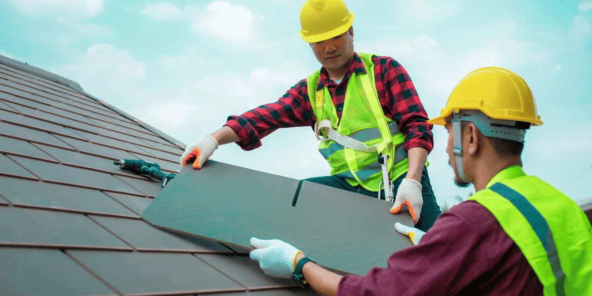 Roofing contractor applying self-adhering ice-and-water shield underlayment during replacement