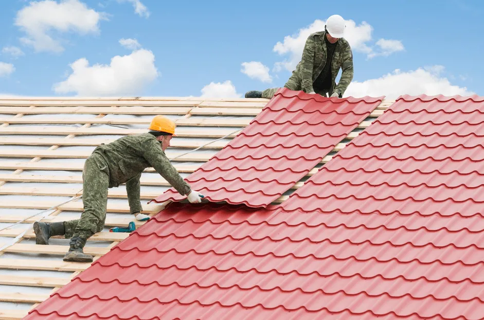 Metal roofing installation crew applying standing seam panels on commercial structure